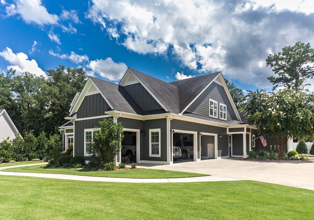 Dark gray home with multiple garage bays